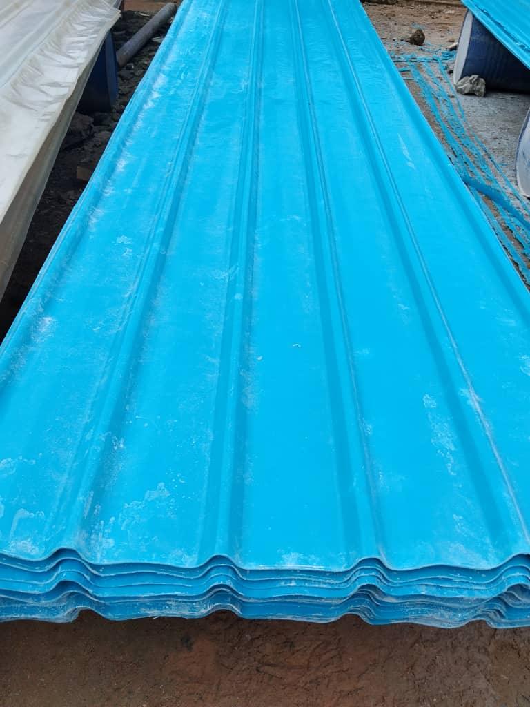 Stack of blue corrugated fibre glass roofing sheets manufactured by Bestower